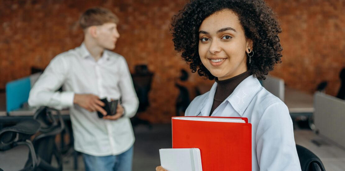 a lady stand with red file