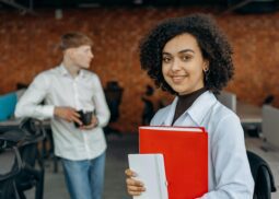 a lady stand with red file